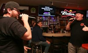 two Gridiron Grill & Tap House patrons sing a duet at Karaoke night