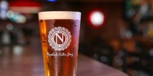 A Ninkassi branded glass of beer sits on the bar at the GridIron Grill & Tap House in Springfield, Oregon